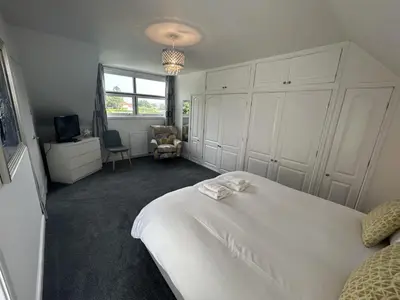 a bedroom with a white bed and a window at The Stables in Symington in Symington