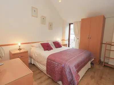 a bedroom with a bed and a dresser and a bed sidx sidx sidx sidx at The Hayloft in Wigton