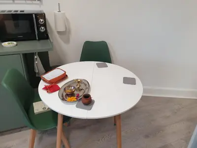 a white table with a plate of food on it at Modern Two-Bedroom Apartment Near River with Free Parking & WiFi in Dumfries
