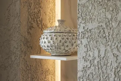 a vase sitting on a shelf next to a wall at The Hide - Ridgestone in Penrith