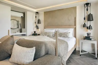 a bedroom with a large bed and a couch at The Hide - Ridgestone in Penrith