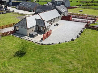 an aerial view of a house with a large yard at Middle Byre in Girthon