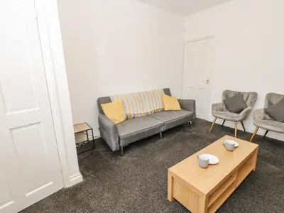 a living room with a couch and a coffee table at Cumberland House in Workington