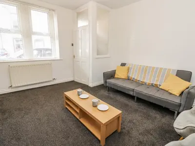 a living room with a couch and a coffee table at Cumberland House in Workington