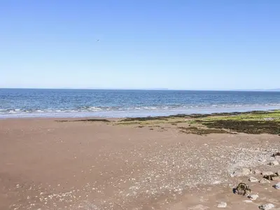 an empty beach with the ocean in the background at Keekle Terrace in Cleator Moor