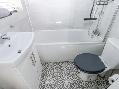 a white bathroom with a toilet and a sink at Keekle Terrace in Cleator Moor