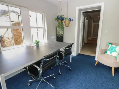 a large desk in a room with two chairs at Hampton House in St Bees