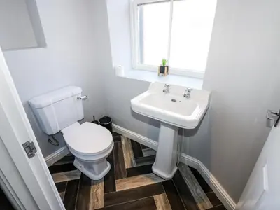 a bathroom with a toilet and a sink at Lowther House in Whitehaven