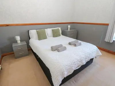 a bedroom with a bed with two towels on it at Bolton Terrace in Workington