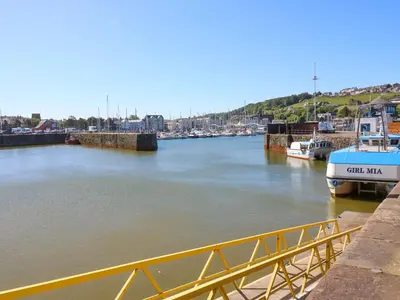 a view of a river with boats docked at Lowther Suite in Whitehaven