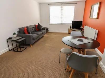 a living room with a couch and a table at Curwen Apartment in Workington