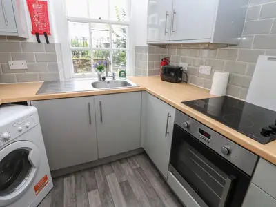 a small kitchen with a sink and a dishwasher at Georgian Town House in Whitehaven