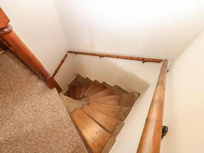 an overhead view of a wooden spiral staircase in a house at Kirkgate Cottage in Cockermouth
