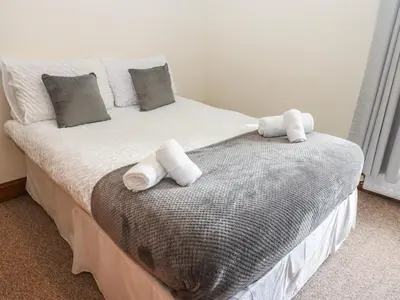 a bedroom with a bed with towels on it at Kirkgate Cottage in Cockermouth
