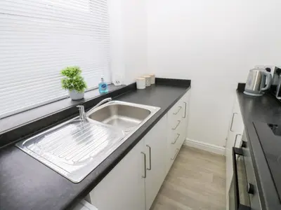 a kitchen with a sink and a counter top at Holly House in Whitehaven