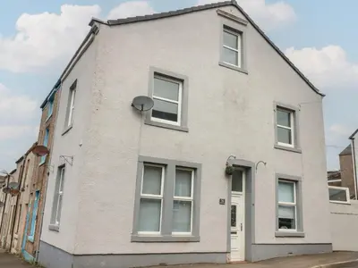 a white house with white windows on a street at Ennerdale Edge in Cleator