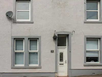a white building with windows and a door at Ennerdale Edge in Cleator