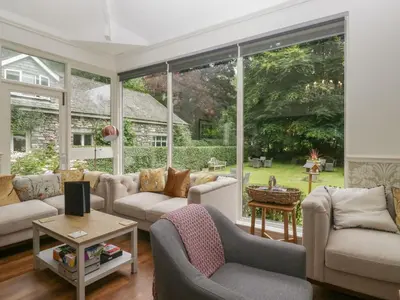 a living room filled with furniture and a large window at Shelley in Ambleside