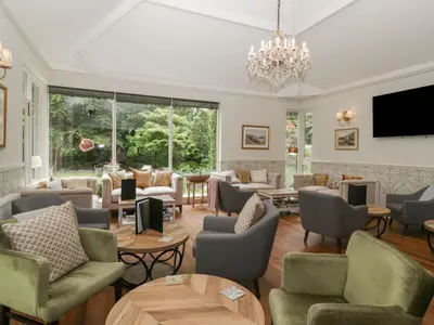 a large living room with couches and tables at Shelley in Ambleside