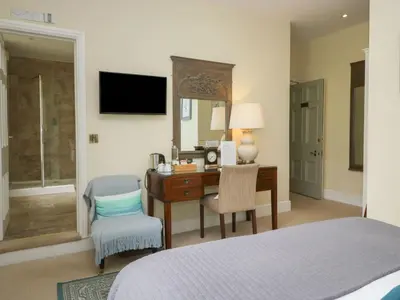 a bedroom with a desk and a chair and a bed at Coleridge in Ambleside