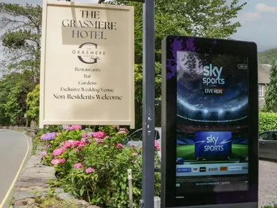 a sign for the conservery hotel next to a road at Coleridge in Ambleside