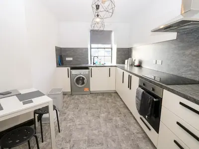 a kitchen with a washer and dryer at Lowther Penthouse in Whitehaven