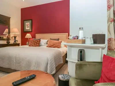 a bedroom with a bed with a remote control on it at Dorothy in Ambleside