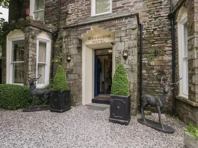 two deer statues in front of a building at Dorothy in Ambleside