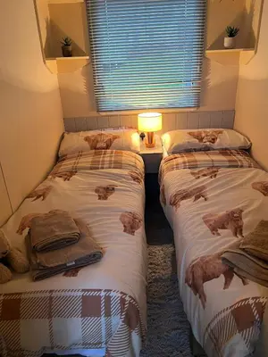 three beds in a room with cats on them at 108 Lochview in Newton Stewart