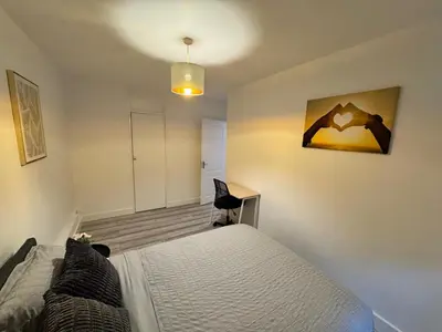 a bedroom with a bed and a desk and a chair at Modern 3-Bed Flat Stylish Family-Friendly in Moffat