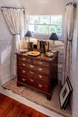 a dresser with two lamps on it in a bedroom at Spedlins Castle in Templand