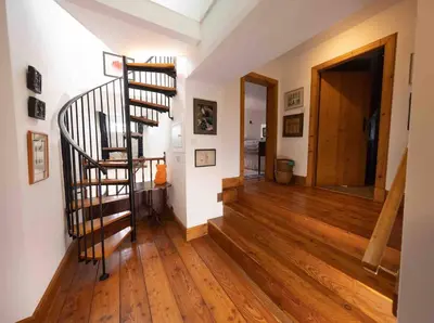 a hallway with a spiral staircase in a house at Spedlins Castle in Templand