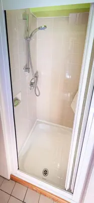 a bathroom with a shower with a tub at Spedlins Castle in Templand