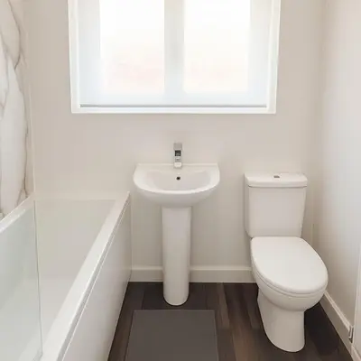 a white bathroom with a toilet and a sink at Near West Cumbria Hospital in Whitehaven