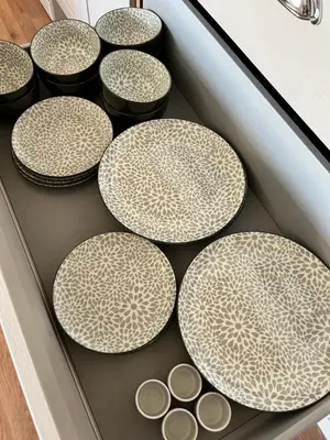 a drawer with four large plates and bowls on it at Wheatsheaf Flat