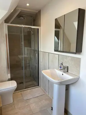 a bathroom with a sink and a shower at Wheatsheaf Flat