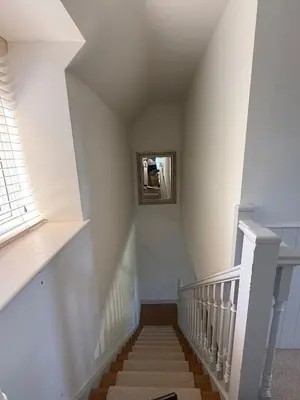 a staircase in a house with a stair case at Cosy Cottage in Cotswolds in Moffat