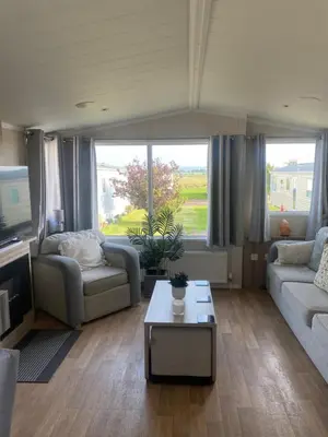 a living room with two couches and a coffee table at surfshack caravan MH19D manor house park in Mawbray