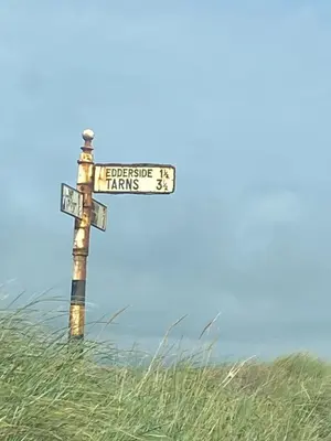 a street sign in the middle of a field at surfshack caravan MH19D manor house park in Mawbray