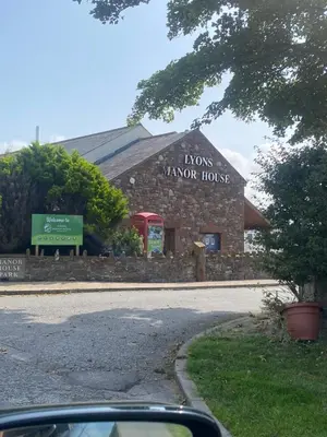 a building with a sign on the side of it at surfshack caravan MH19D manor house park in Mawbray
