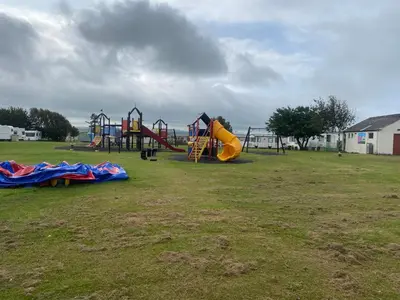 a park with a playground with a slide at surfshack caravan MH19D manor house park in Mawbray
