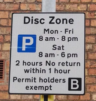 a street sign on a pole next to a brick wall at Double Ensuite - City centre homestay - Peterill Room - in Carlisle