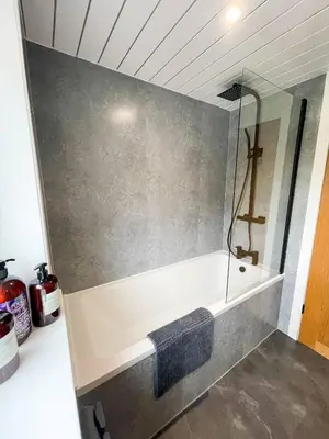 a bathroom with a bath tub with a sink at The Retreat, Cosy 1 Bed Cottage, Town Centre Location in Kirkcudbright