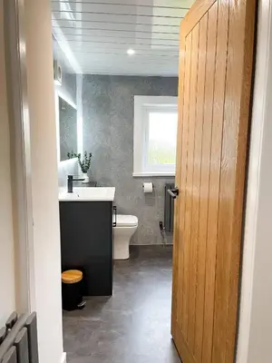 a bathroom with a white toilet and a sink at The Retreat, Cosy 1 Bed Cottage, Town Centre Location in Kirkcudbright