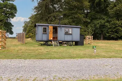 a tiny house sitting on top of a field at Redwood in Moffat