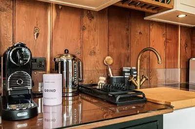 a kitchen counter with a coffee maker on a counter top at Redwood in Moffat
