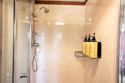 a bathroom with a shower with a glass shower stall at Redwood in Moffat