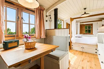 a bedroom with a bed and a desk in a room at Quercus & Redwood - Sleeps 4 in Moffat