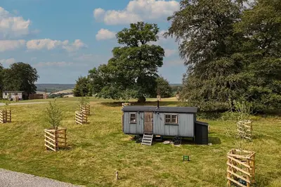 a small shed in the middle of a field at Quercus & Redwood - Sleeps 4 in Moffat