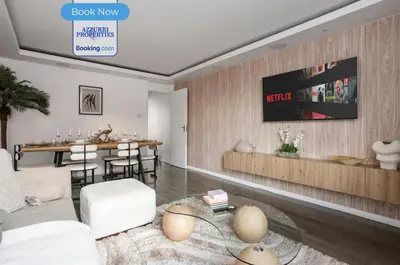a living room with a couch and a table at Cozy 4-Bedrooms House By Azzurri Properties Short Lets & Serviced Accommodation London With Private Garden, Wi-Fi in Moffat
